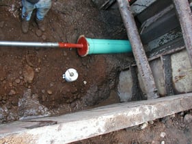 Pipe-being-pushed-and-set-into-manhole-1024x768-1