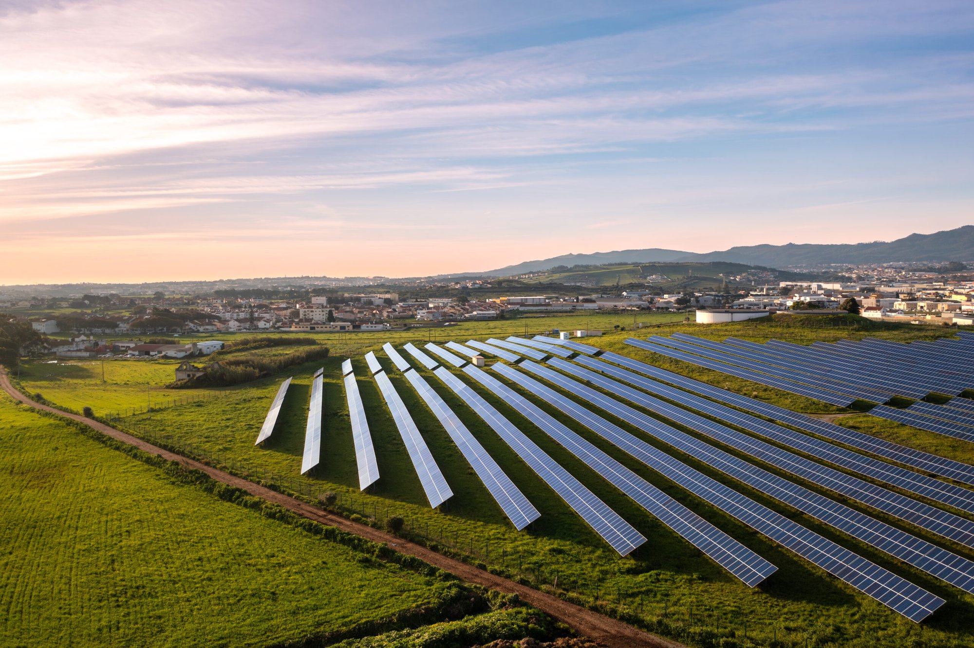 aerial-shot-of-solar-power-plant-on-lush-field-in-2024-09-05-23-09-21-utc-scaled-1-1